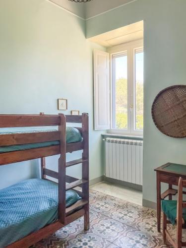 a room with two bunk beds and a table at Dimora Storica Villa Pietralunga in Nicosia