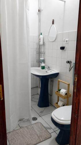 a bathroom with a sink and a toilet at Private Pool River View Villa in Baião