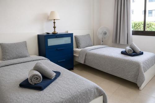 a bedroom with two beds and a blue dresser at Seguro Spacious apartment with roomy terrace, newly renovated in Puerto de Santiago