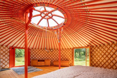 a room with a large wooden ceiling with a window at Jurta na Jitrech in Tábor