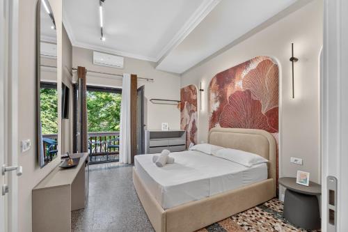 a bedroom with a bed and a balcony at 2115 Boutique Hotel in Durrës