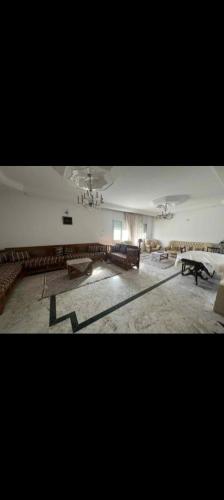 a large room with tables and benches in it at villa zgolli in Korba
