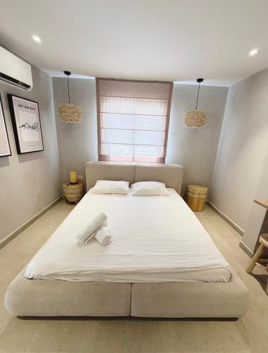a large white bed in a room with a window at Villa Sea House in Eilat
