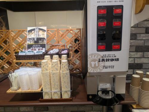 a store window with a coffee machine and plates at APA Hotel Muroran in Muroran