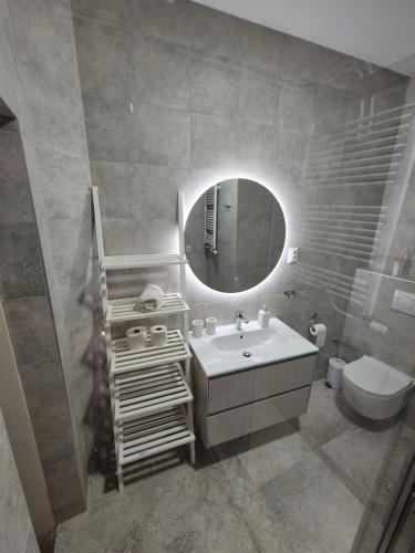 a bathroom with a sink and a mirror at Apartment Laura & Lucija in Osijek
