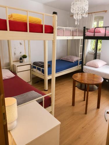 a room with three bunk beds and a table at Guest House Elizabeta in Split