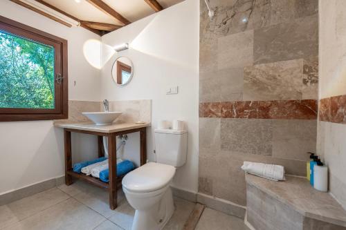a bathroom with a toilet and a sink at Kabak Avalon Bungalows in Faralya