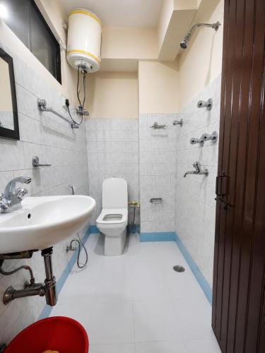 a bathroom with a sink and a toilet at Hotel Darjeeling palace in Darjeeling