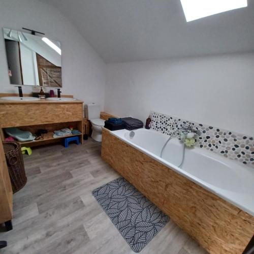a large bathroom with a tub and a sink at A l'éc'Art in Wellin