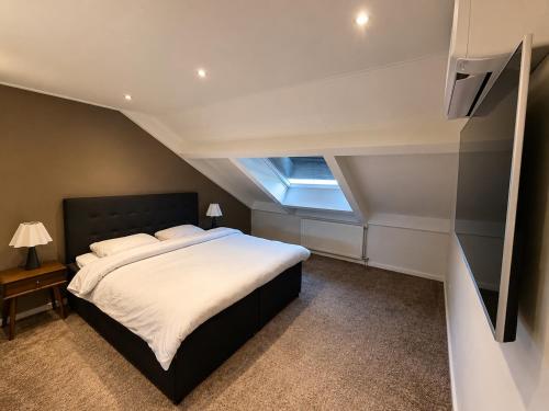 a bedroom with a large bed and a window at LUXURY Home Axel in Axel