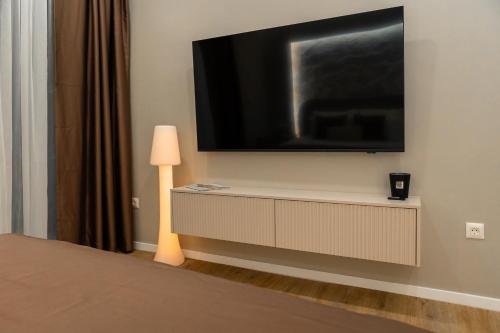 a flat screen tv on a wall in a room at Armal Studio in Mostar