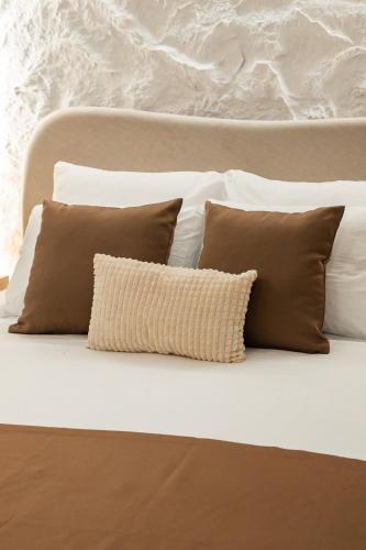 a bunch of pillows sitting on a bed at Armal Studio in Mostar