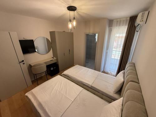 a bedroom with a large bed and a couch at Struga Lake Suites in Struga