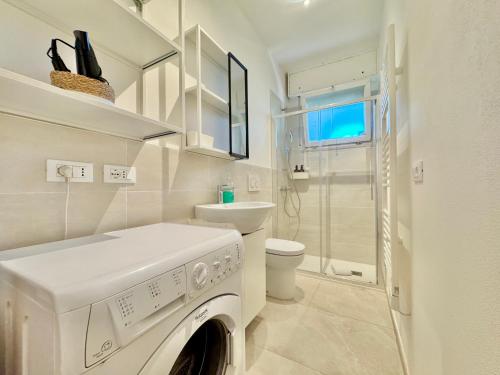 a white laundry room with a washing machine in it at Quarzo e Acquamarina in Lido Adriano