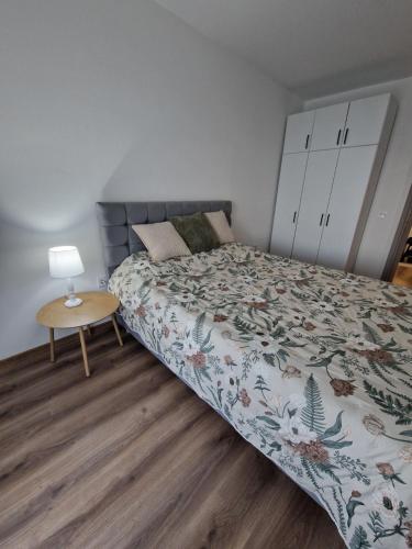 a bedroom with a bed and a wooden floor at Apartment Dalas 2 Star Dojran in Star Dojran