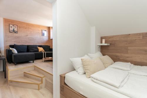 a living room with a white couch and a living room with a couch at La casa de papel Apartment in Bjelovar