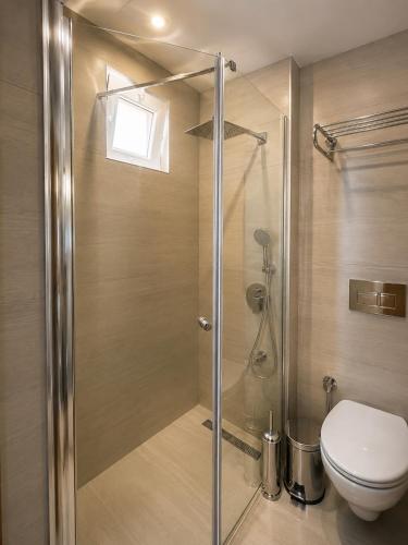 a shower stall with a toilet in a bathroom at Butik İsabel Otel in Kemer