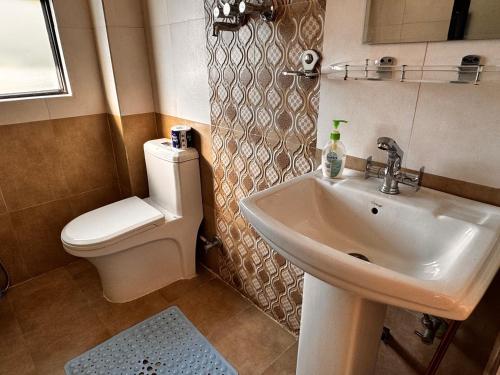 a bathroom with a sink and a toilet at Niru Yoga Homestay sound healing & hiking retreat in Bhaktapur