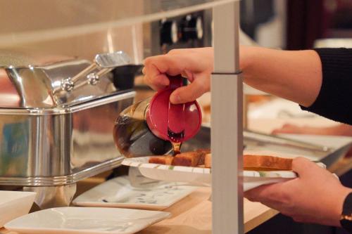 a person is preparing food in a kitchen at Hotel Stanford in New York