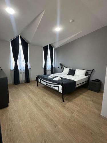 a bedroom with a bed with black and white pillows at Old Well Hotel in Tsaghkadzor