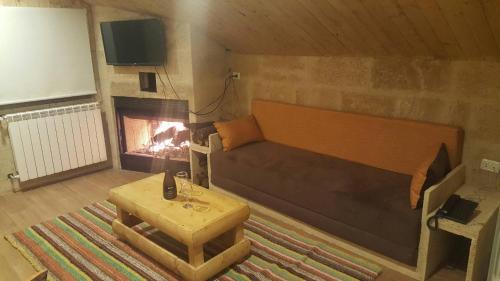 a living room with a couch and a fireplace at Villetta di Faraya in Fārayyā