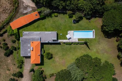an aerial view of a house with a pool at Portugal Active Oliveiras Farm in Viana do Castelo