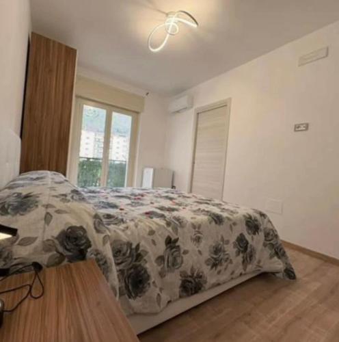 a bedroom with a bed with a flowered blanket at B&b Antonia in SantʼAntonio Abate