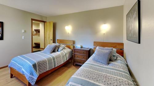 a bedroom with two beds and a dresser and a mirror at 135 Marina Place in Dillon