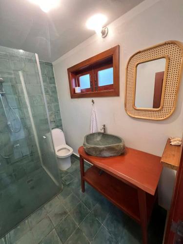 a bathroom with a sink and a shower and a mirror at Family-friendly accomodation with sea view in Kaôh Kon