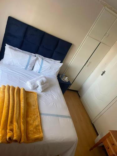 a bedroom with a white bed with two towels on it at Executive B & B in Beacon Bay