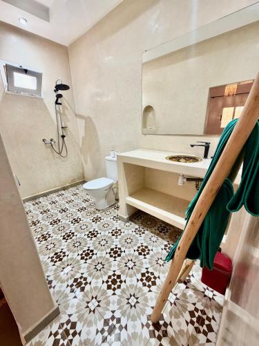a bathroom with a sink and a toilet at Dar Rime in Ghazoua