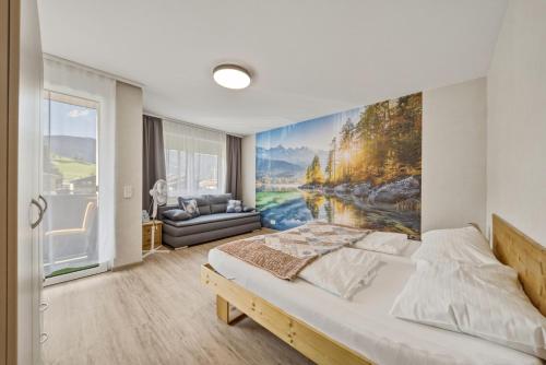 a bedroom with a large painting on the wall at Kaprun Apartments in Kaprun