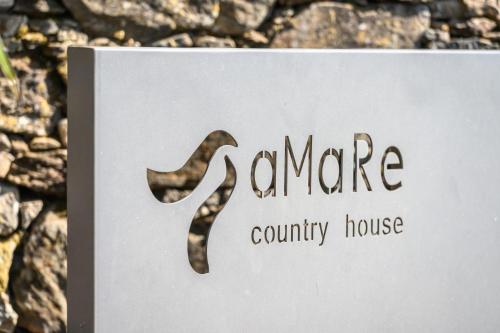 a sign for a community house with a saxophone at aMaRe Country House in Caminha
