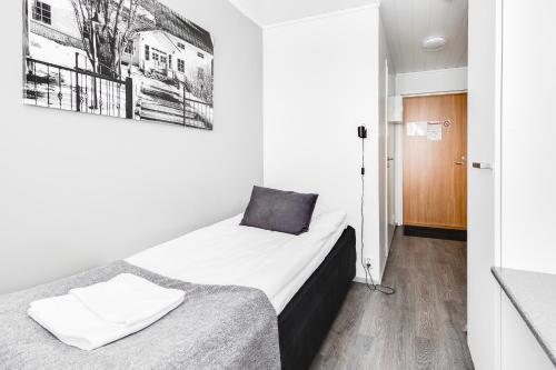a small room with two beds and a hallway at LODGE Aparthotel Raahe in Raahe
