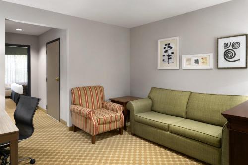 a living room with a couch and a chair at Country Inn & Suites by Radisson, Gettysburg, PA in Gettysburg