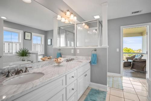 a bathroom with two sinks and a large mirror at Harbor Island 71 Harbor Drive in Nautical Watch Villas