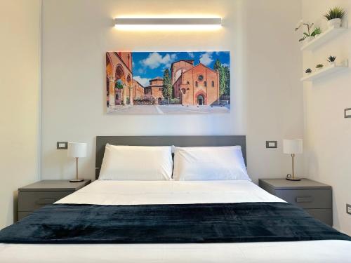 a bedroom with a bed with a painting on the wall at Demetra Apartment in Bologna