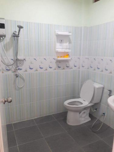a bathroom with a toilet and a shower stall at Pingpong 's house Koh chang in Ko Chang