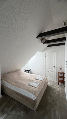 a bedroom with a bed in a white room at Lotmiškio 1 in Neringa