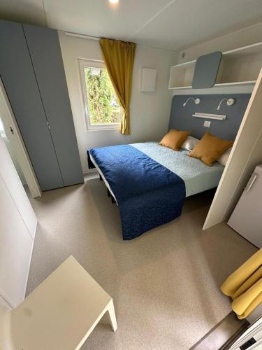 a small bedroom with a bed and a window at Camping & Resort Valle Romantica in Cannobio