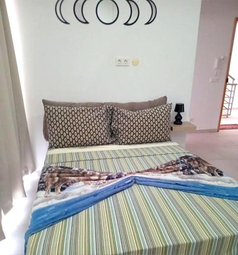 a bedroom with a bed with a striped mattress at Beach 2 Min - Bright Central Studio - AC in Santa Maria