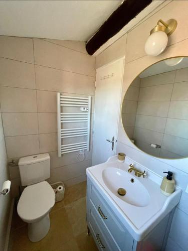 a bathroom with a sink and a toilet and a mirror at Downtown apartment in Marseille