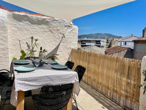 a table on a balcony with a table and chairs at Downtown apartment in Marseille