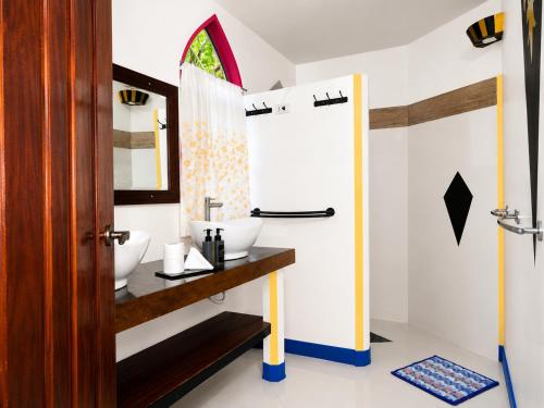 a bathroom with two sinks and a mirror at MG Chateau Resort in El Nido