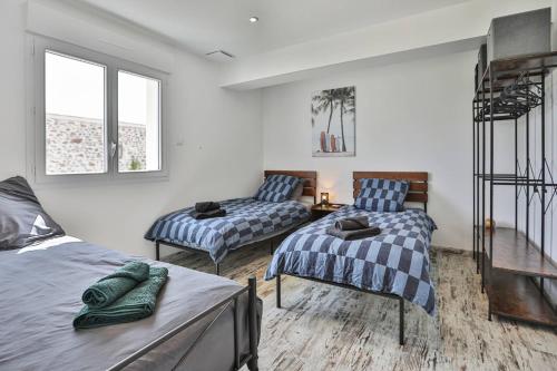 a bedroom with two beds and a staircase at L'échappé Belle du Bessay in Avrillé