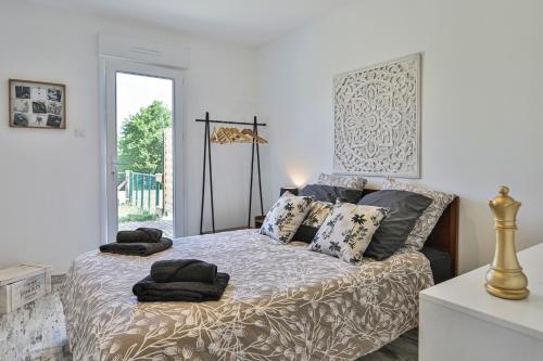 a bedroom with a bed with pillows on it at Gite du Bord de mer in Avrillé