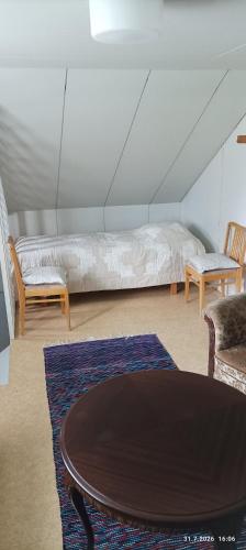 a room with a bed and a table and chairs at Veteli in Veteli