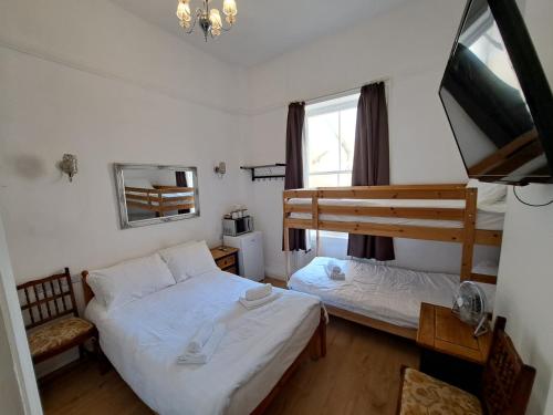 a bedroom with two beds and a bunk bed at The West Pier Residence in Brighton & Hove