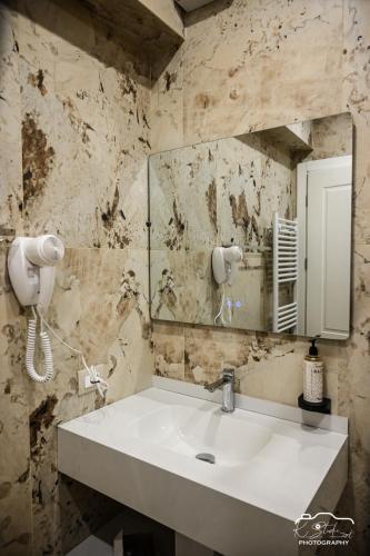 a bathroom with a sink and a mirror at Rubin Boutique in Korçë
