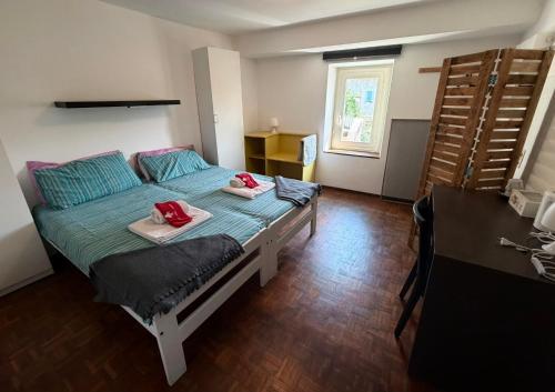 a bedroom with a bed with two towels on it at La Locanda del Viandante in Mendrisio